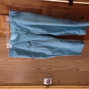 Brand is docker's, size 14, and the color is teal